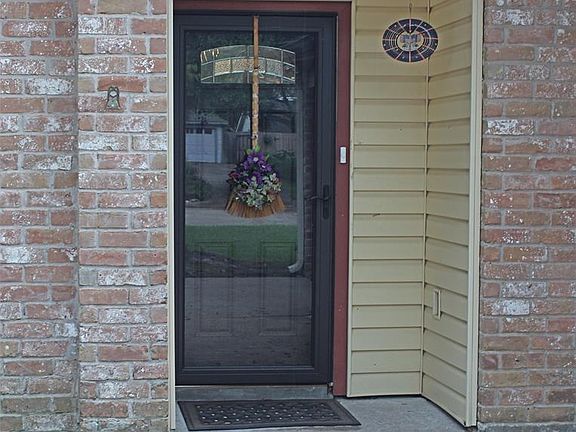 Front door with storm door too. Brick and vinyl exterior for ease in maintenance.