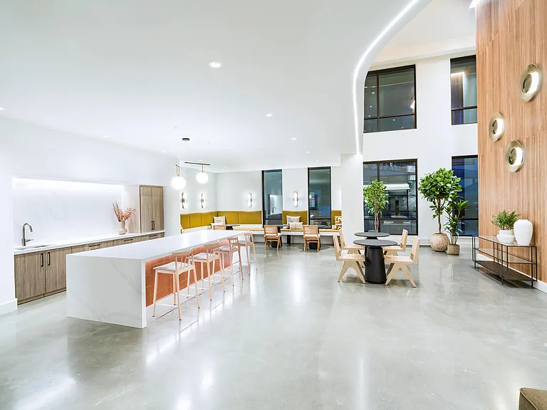 A bright gathering space with a sleek kitchen, lounge seating, and room to connect.