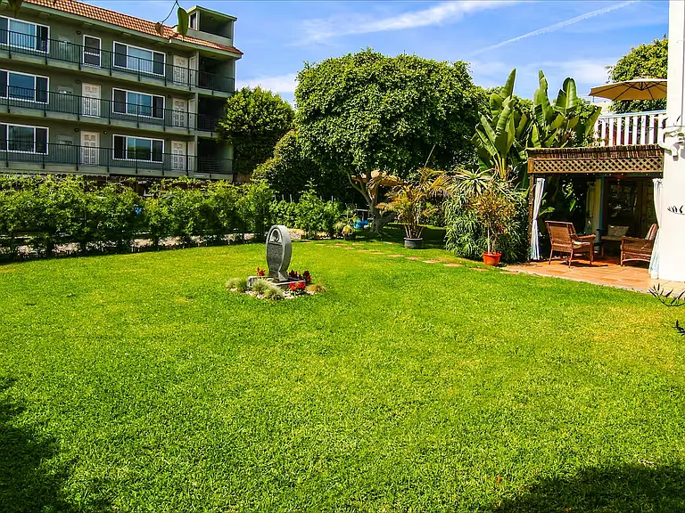 Large yard with Gated Parking ~ just beyond hedges (center left).