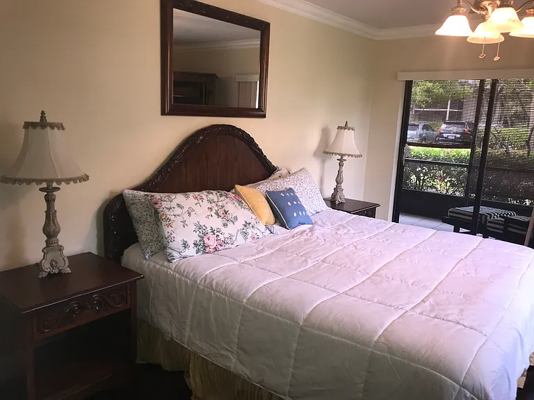 Master bedroom with king bed, two night stands, two dressers and smart TV