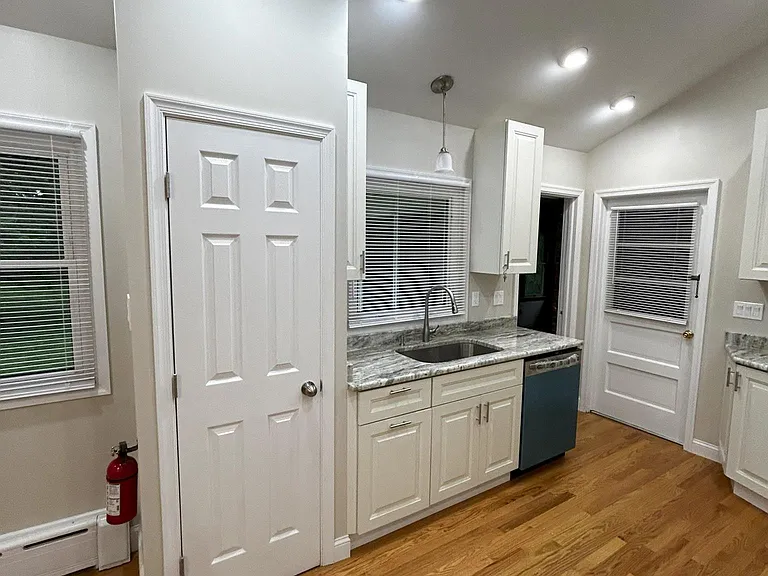 Kitchen pantry, large sink, dishwasher. Door opens to garage