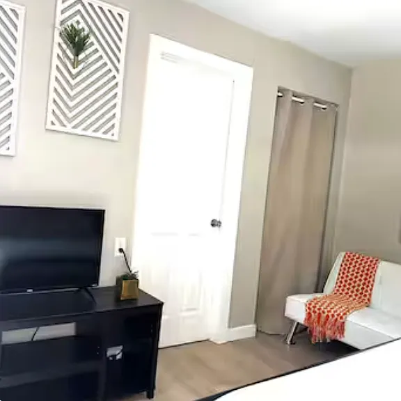 Guest Bedroom 2- Has private entrance from the back yard. Closet , Window Unit for AC. Ensuite shared bathroom