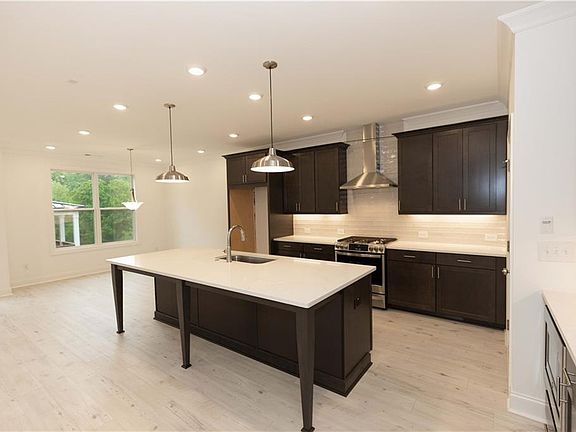 Amazing gourmet kitchen features the Warm Slate design collection.