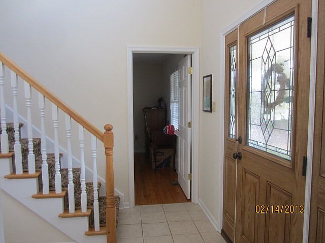 Foyer has large ceramic tiles, a two-story ceiling height and great sunlight 
