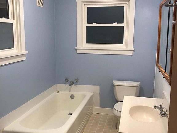 Large, clean bathroom with frosted windows for privacy.