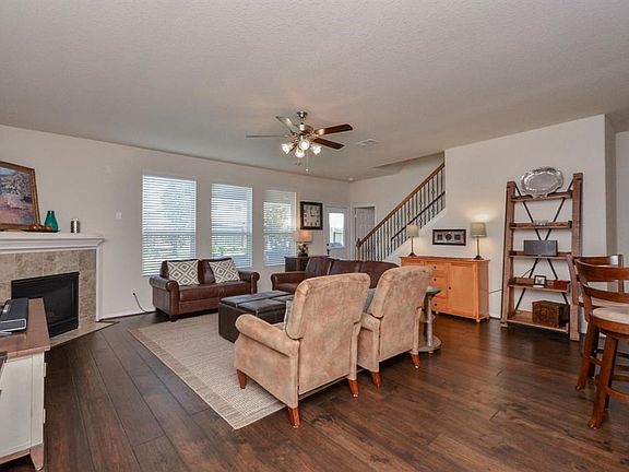 Updated Hardwood flooring in the spacious family room. The picture windows provide views of the lushly landscaped yard.