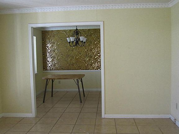 Formal living area and formal dining area separated by open wall