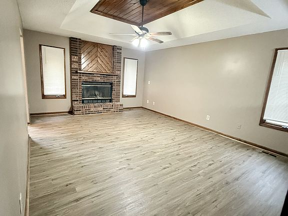 Oversized living room with wood accents & brick fireplace