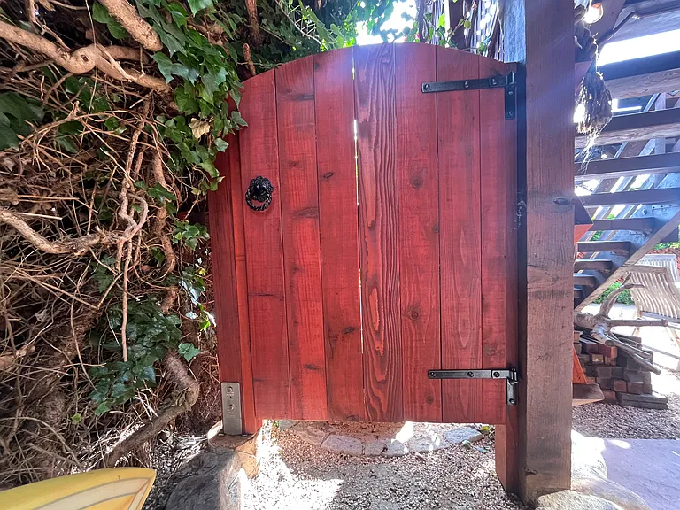 Gate to private outdoor hot and cold galvanized tub, secluded space