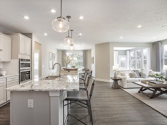 Open Concept Layout Featuring the Dining Room, Gathering Room and Kitchen