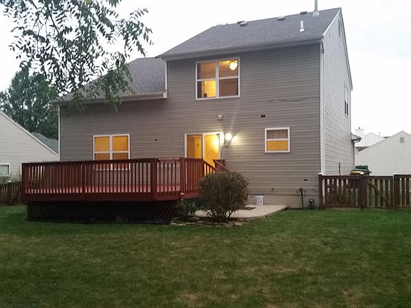 Rear View of Home with Deck and Fenced Yard
