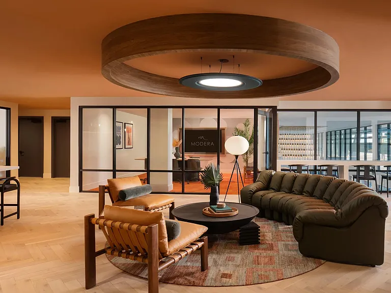 Warm tones, layered textures, and contemporary design set the tone inside Modera Rio Salado's inviting resident lounge.