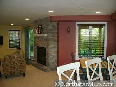 Stone fireplace in basement family room. 