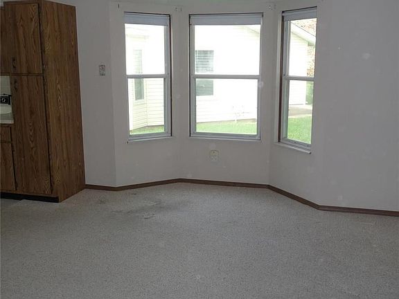 Dining area with bay window and vaulted ceiling.