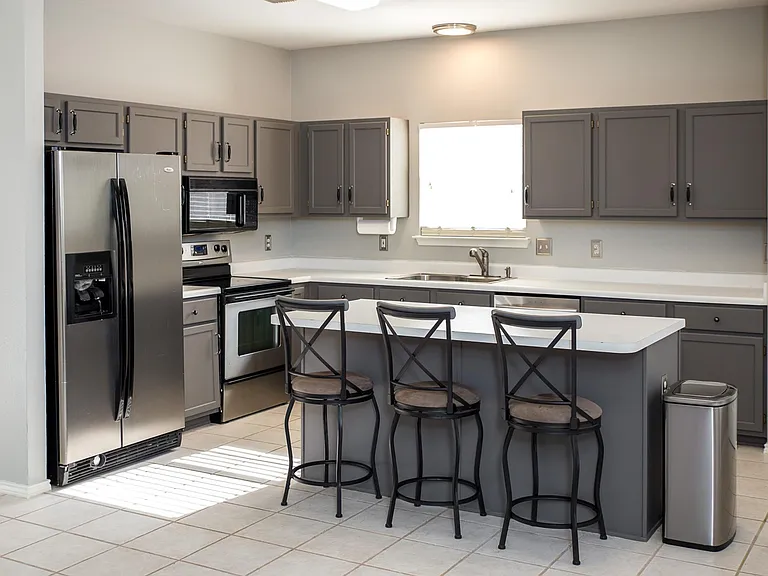 Kitchen with a Large Center Island, Abundant Cabinetry, and Stainless Steel Appliances