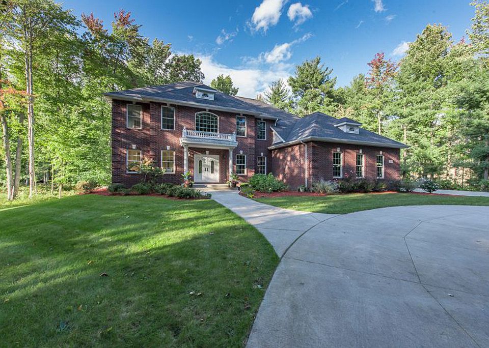 Custom-built exquisite home by Cobblestone Homes located on 2 acres in Larkin Township - you'll love the private setting as you pull in to your circular driveway surrounded by wooded nature.  The home captures your eye with the attractive brick work and Juliet balcony and columns.  If you need space, you'll love the large, flowing rooms in the entire home with over 3800 square feet of living space, a full basement with plenty of egress windows to bring in daylight, and a 3-car attached garage.  The home features 4 bedrooms, an elegant master suite with sitting area, huge walk-in closet and lovely private bath, an outstanding kitchen with gourmet stainless appliances, gorgeous cherry hardwood floors, vaulted ceilings, 2-way fireplace between the family room and main floor den plus living and dining rooms for entertaining.  Many extras are provided such as central vacuum, whole house air exchanger and on demand hot water heat plus back-up - you'll want to stay forever!  Call today!