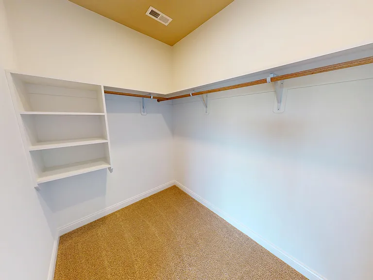 The walk-in closet in The Pyle floor plan bedroom includes custom-built shelving. The walk-in closet in The Pyle floor plan bedroom includes custom-built shelving.