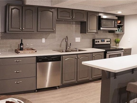 Kitchen includes up to date appliances (fridge/freezer, dishwasher, stove, oven, microwave, garbage disposal).