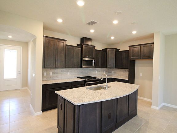 Spacious Kitchen with Dark Cabinets and Island