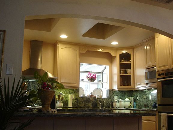 Custom made solid maple cabinets with granite countertops & backsplash.