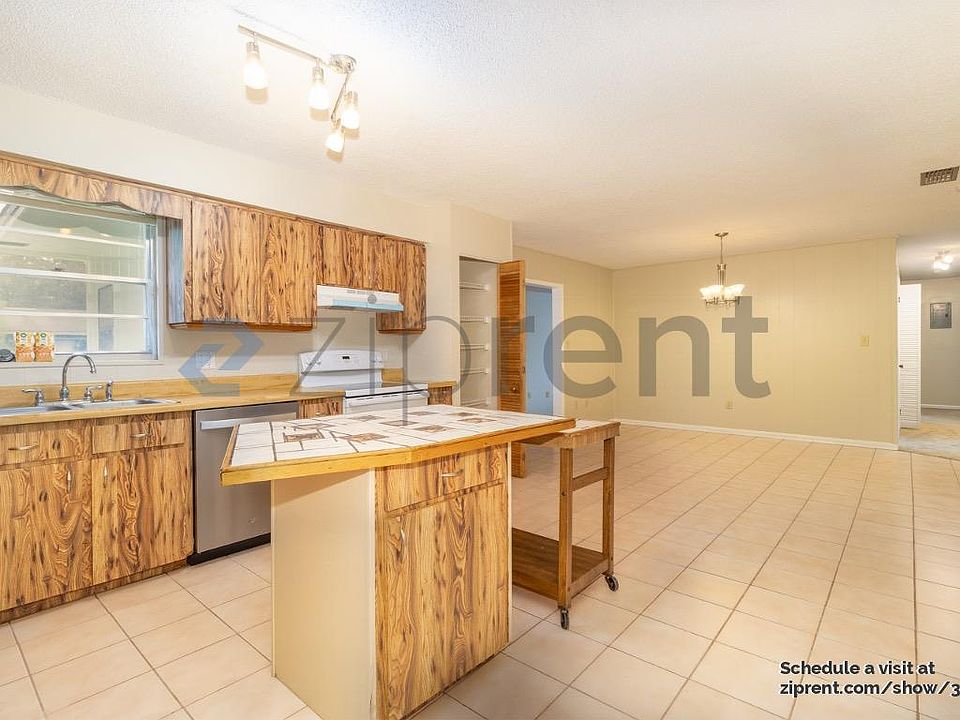 Beautiful kitchen with an Island. New 2024 dishwasher! Open dining room