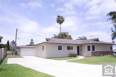 Front of home, cement driveway, parking pad, side lawn, garage