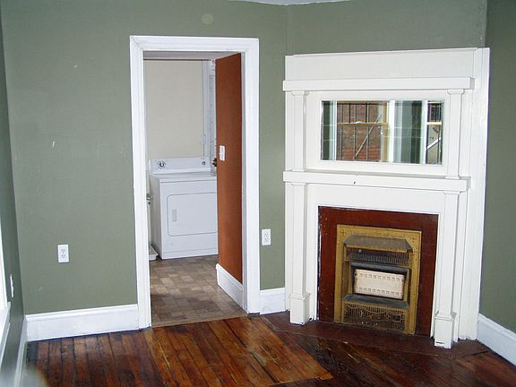 Bedroom with pass entrance to en-suite laundry and dressing area. Bedroom has a coffered ceiling