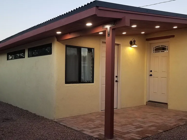 Well lit, brick paver, front porch. Door to livingroom/bedroom. Door to master bedroom.