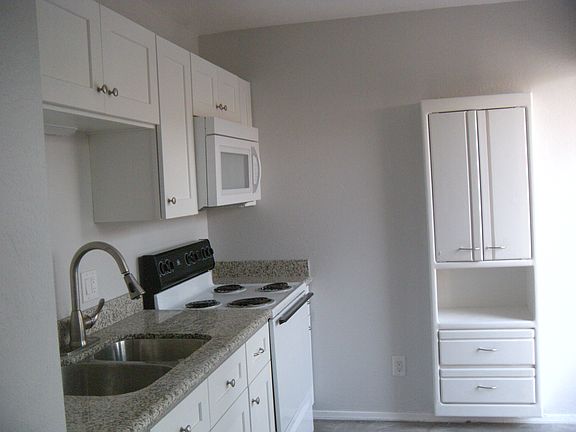 Kitchen area with extra cabinet and granite counter tops