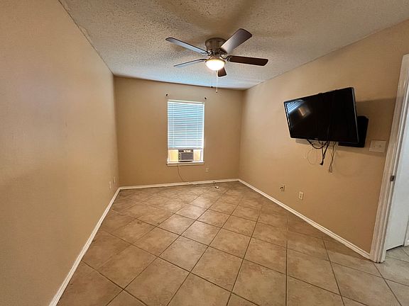 Master bedroom with security camera monitor.