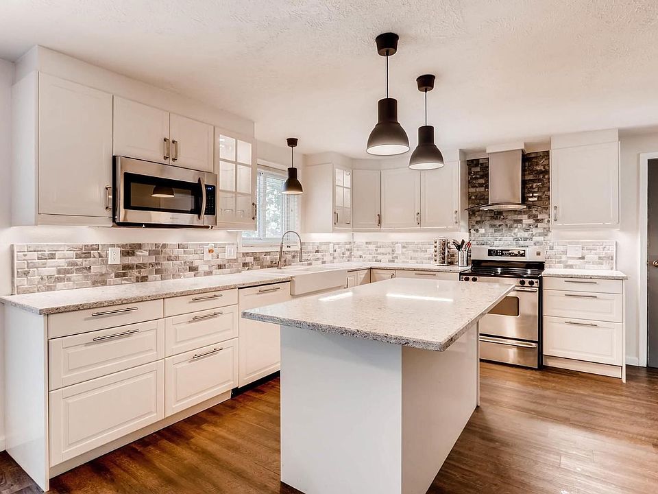 Stylish remodeled kitchen with soft-closing drawers, brand new quartz countertops, hidden dishwasher and new appliances