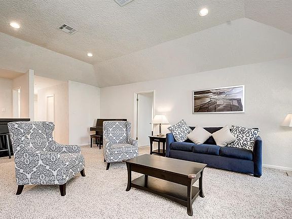 The living room also has recessed lighting.