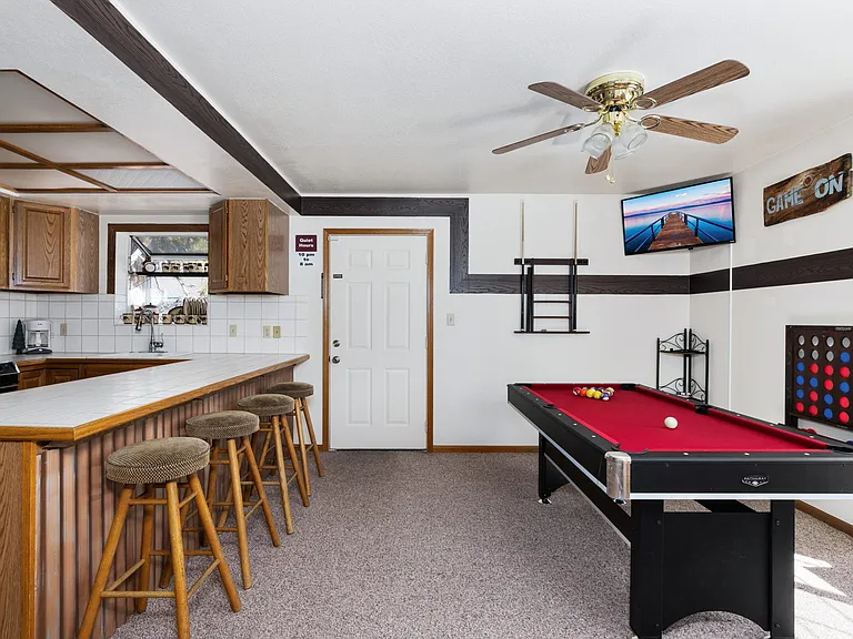 Upstairs fully stocked kitchen, island bar, game room, pool table, smart TV, and door to outside Hot Tub and 360 walk around HUGE deck.