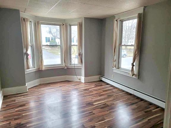 Spacious livingroom with nice light from the bay window. New flooring and ample space for comfy furniture.