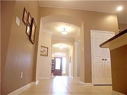 Elegant halls with arched entries and tile floors. House is equipped with alarm system.