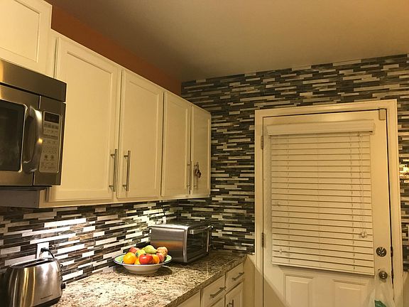 Private patio deck access through the kitchen - custom blinds on all windows