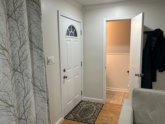 Entry to living room with half bath