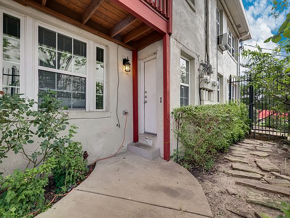 Door to Unit #2 from parking lot. Courtyard view on right.