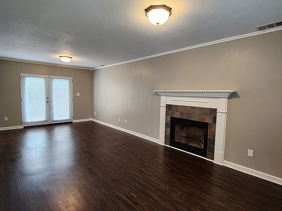 Living room with fireplace. Dining area is by the French doors.