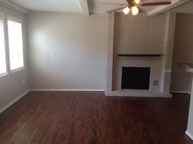 Living room with wood burning fireplace/mantel