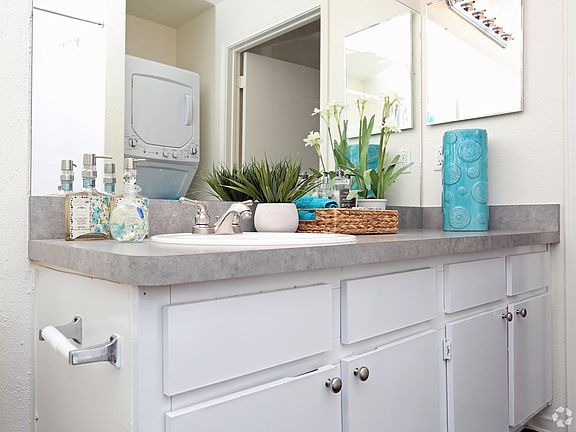 Bright bathroom with washer and dryer area