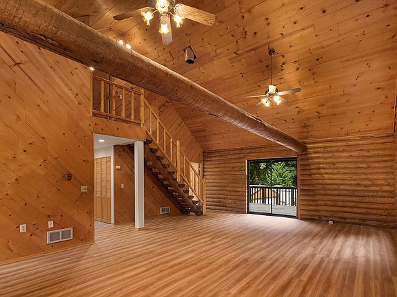 Another view of Livingroom. On the left in the picture hall to kitchen laundry and bathroom. At the bottom of stairs doorway to bedroom. Out the slider to huge private deck.