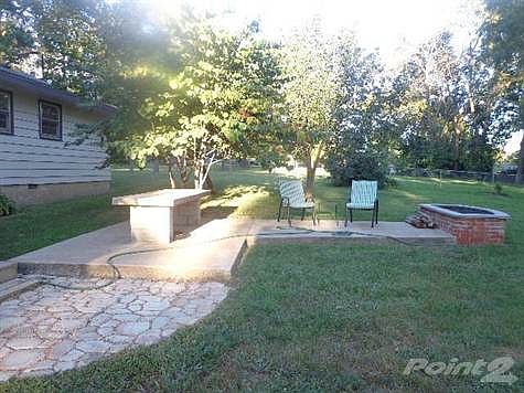 If you love the outdoors, You will love this fire-pit set up!  Patio are off the deck is stamped to look like stone and then additional patio area!  All on 1.1 Acres inside the city limits, but you have so much privacy!
