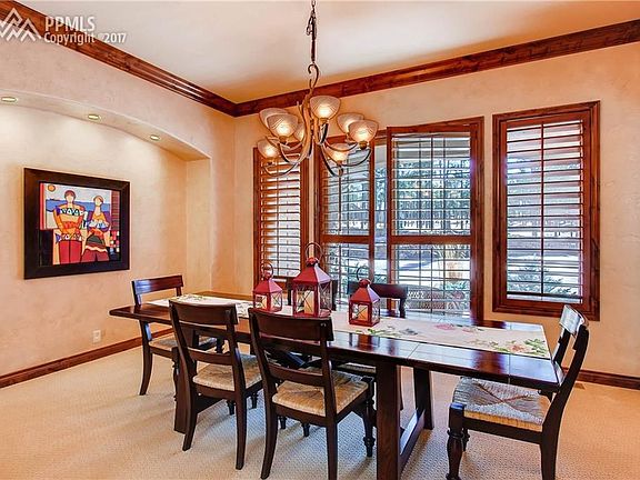 Formal Dining room with plantation shutters, crown molding and wall for art disp