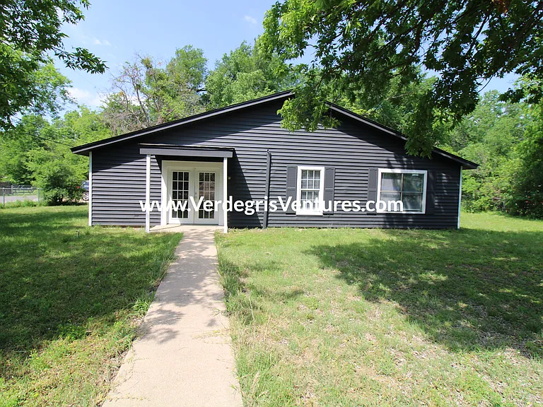 The front of the home faces Kenwood Ave and features a spacious, open grass yard
