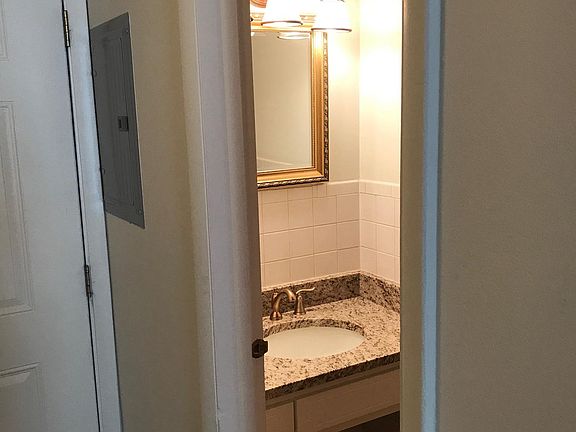 Half bath downstairs with granite countertop.