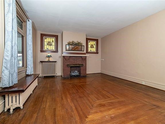 Original stained glass windows bring warmth and beauty to the family room.