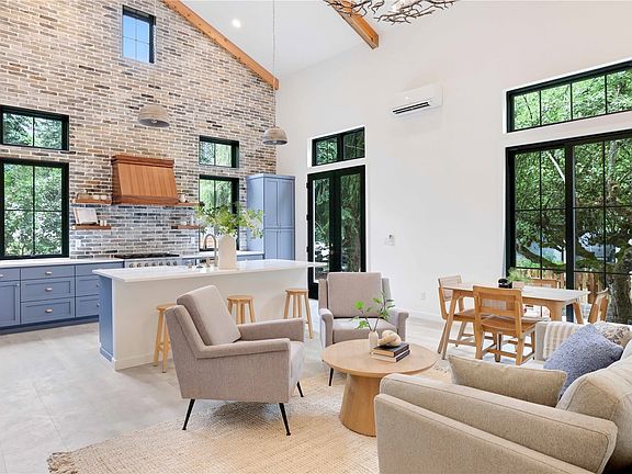 Looking towards the glass front door, lights pours into the main living space.>
