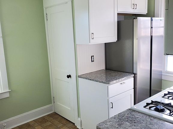 Cabinets and refrigerator. Washer and dryer behind door.