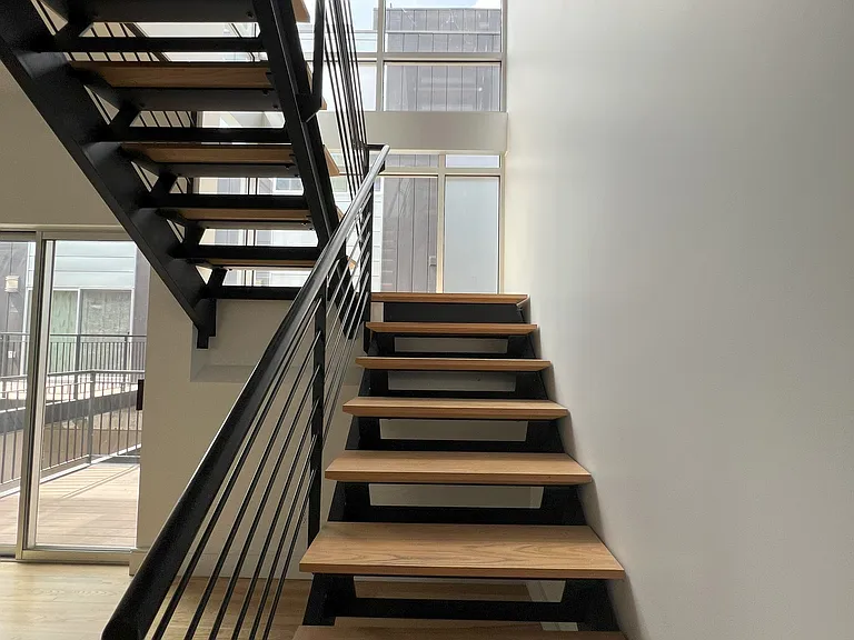 Stairway between second floor kitchen and third floor master bedroom